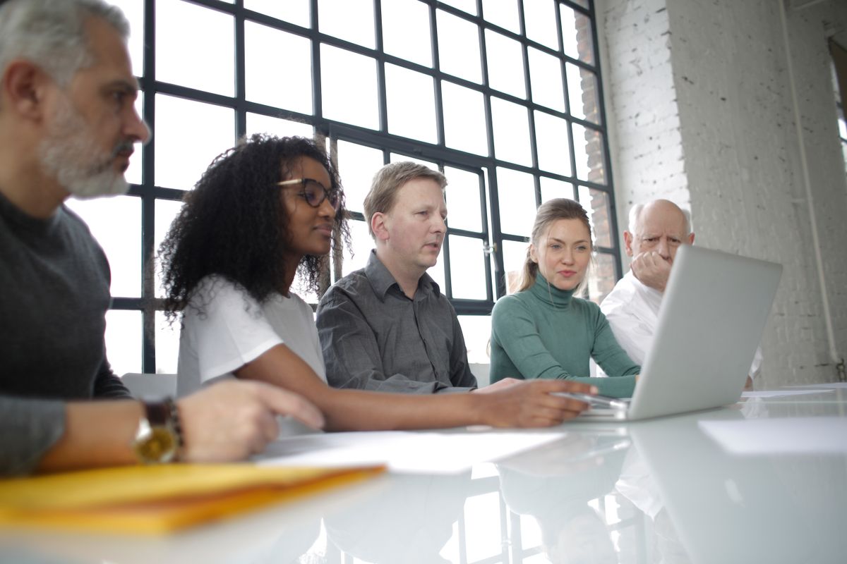 Small business team collaborating around a laptop