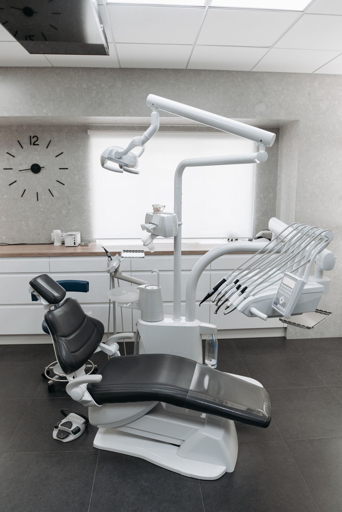 Modern dental treatment room with chair and equipment